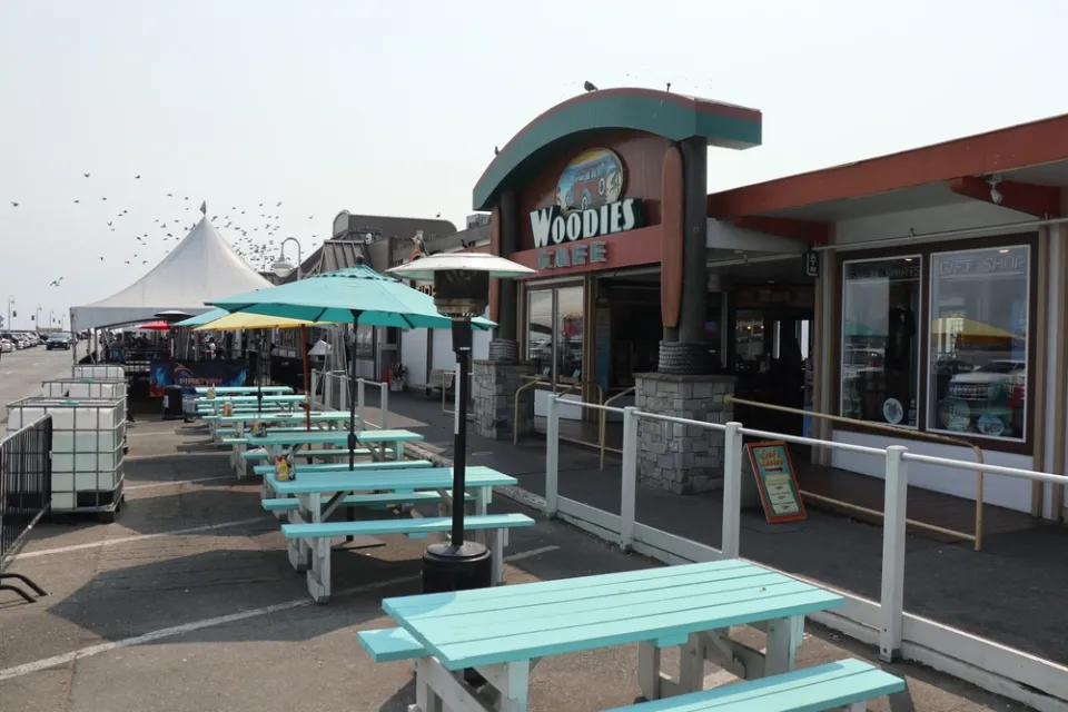 The former parking of Woodies restaurant is filled with empty picnic tables for dining during the Covid-19 pandemic.